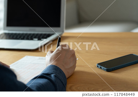 A man filling out an inheritance tax return A man filling out an inheritance tax return 117848449