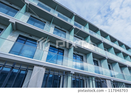 Balconies and windows of the new apartment house. 117848703