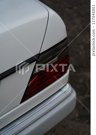 The back of a white car. The lantern of a white car in the evening The back of a white car. The lantern of a white car in the evening 117848801