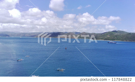 Aerial view of a peaceful Cemare beach in Lombok, Indonesia. Aerial view of a peaceful Cemare beach in Lombok, Indonesia. 117848822