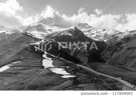 Georgian mountain landscape with a road and Mount Kazbek Georgian mountain landscape with a road and Mount Kazbek 117849065