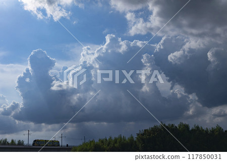 Light rail and cumulonimbus sky 117850031