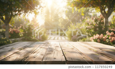 Weathered wooden table and lush garden scene. Ideal for spring and summer promotions or garden decor advertisements. Copy space. Weathered wooden table and lush garden scene. Ideal for spring and summer promotions or garden decor advertisements. Copy space. 117850249