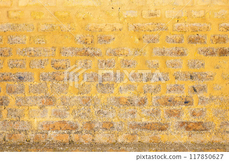 Colorful yellow background of a worn wall, Praesto, Seeland, Denmark 117850627