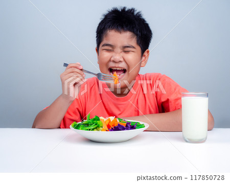 Children like to eat vegetables, Little cute boy eat healthy vegetables, Nutrition healthy eating habits for kids concept, Mixed color vegetables. Children like to eat vegetables, Little cute boy eat healthy vegetables, Nutrition healthy eating habits for kids concept, Mixed color vegetables. 117850728