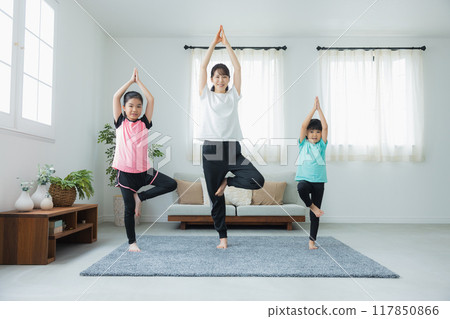 A child stretching in the living room 117850866