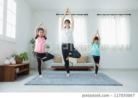 A child stretching in the living room 117850867