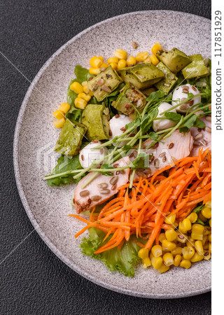 Fresh juicy salad with meat, mozzarella, carrots, lettuce, corn 117851929