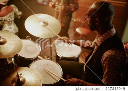 High angle view of unrecognizable young Black man playing drums during jazz concert 117852049