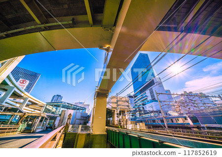 Yokohama cityscape in Japan, overlooking Yokohama Station and trains. JR Yokohama Tower is in the upper right. August 4, 2024 117852619