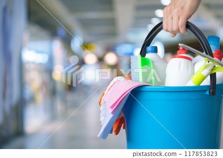 Management holding bucket with cleaning supplies . 117853823