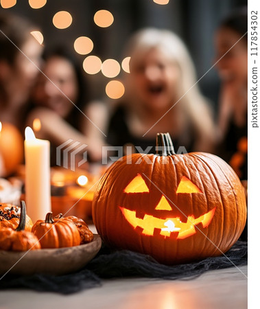 Friends Celebrating Halloween with Carved Pumpkins and Candlelight Decorations 117854302