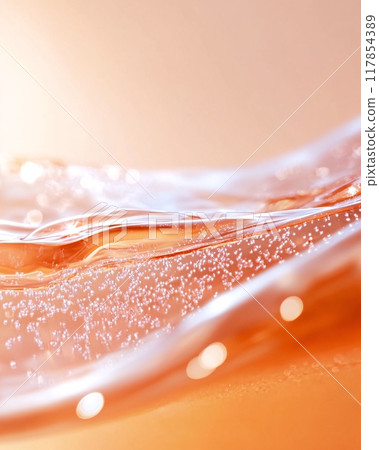 Close-Up of Vibrant Orange Liquid With Bubbles Creating Abstract Patterns 117854389