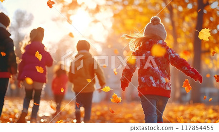 Children Playing in Autumn Park with Colorful Leaves and Sunlight 117854455