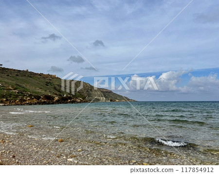 Beautiful sandy beach on the Coast of the island of Gozo, Malta. The Mediterranean Sea. Beautiful sandy beach on the Coast of the island of Gozo, Malta. The Mediterranean Sea. 117854912