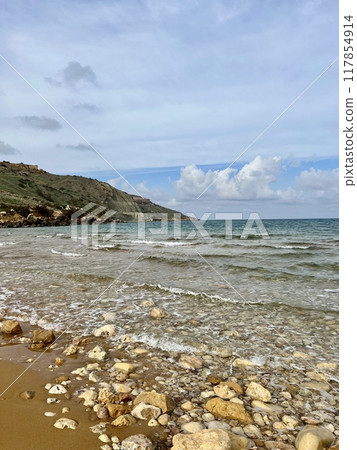 Beautiful sandy beach on the Coast of the island of Gozo, Malta. The Mediterranean Sea. 117854914