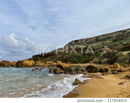 Beautiful sandy beach on the Coast of the island of Gozo, Malta. The Mediterranean Sea. Beautiful sandy beach on the Coast of the island of Gozo, Malta. The Mediterranean Sea. 117854919