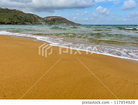 Beautiful sandy beach on the Coast of the island of Gozo, Malta. The Mediterranean Sea. Beautiful sandy beach on the Coast of the island of Gozo, Malta. The Mediterranean Sea. 117854920