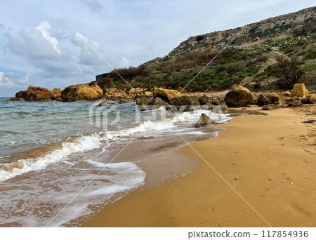 Beautiful sandy beach on the Coast of the island of Gozo. Beautiful sandy beach on the Coast of the island of Gozo. 117854936