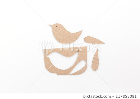 a paper birds sitting on top of a table, cut out of cardboard 117855081
