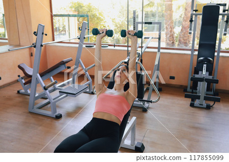 Athlete In The Gym Doing Weightlifting During The Day Athlete In The Gym Doing Weightlifting During The Day 117855099