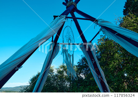 A beachside sun tent with a hanging A beachside sun tent with a hanging 117856324