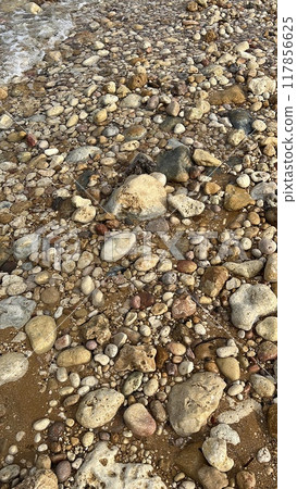 stones on the seashore in the evening, closeup of photo 117856625