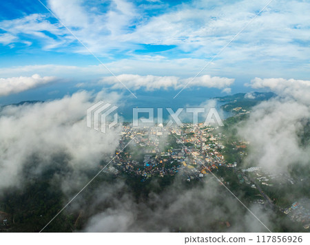 Aerial view of flowing fog waves on mountain tropical rainforest,Bird eye view image over the clouds Amazing nature background with clouds and mountain peaks in Thailand Aerial view of flowing fog waves on mountain tropical rainforest,Bird eye view image over the clouds Amazing nature background with clouds and mountain peaks in Thailand 117856926