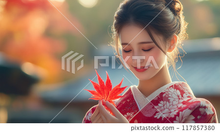 A woman in a kimono enjoying the autumn leaves 117857380