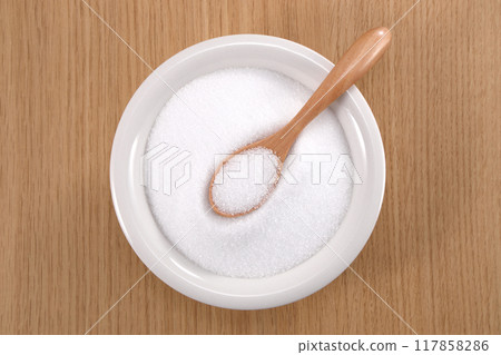Granulated sugar in a white plate Granulated sugar in a white plate 117858286