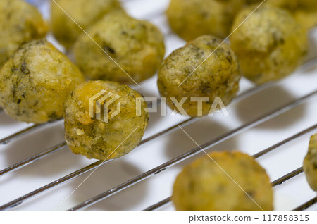 Freshly fried potato balls with green laver flavour Freshly fried potato balls with green laver flavour 117858315