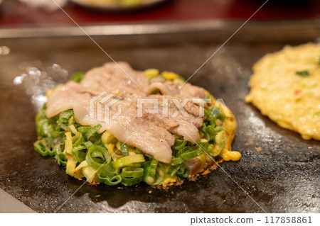 Delicious Osaka specialties Negiyaki and Okonomiyaki Delicious Osaka specialties Negiyaki and Okonomiyaki 117858861
