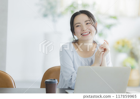Young woman working remotely Young woman working remotely 117859965