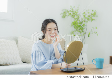 A young woman concerned about her skin condition A young woman concerned about her skin condition 117860033