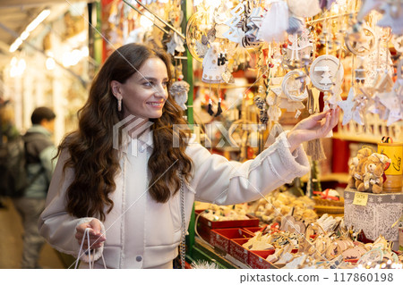 Cheerful woman looking for New Year decorations in street market 117860198