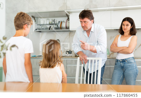 Parents scold their children in kitchen at home 117860455