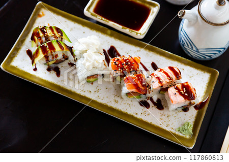 Japanese Uramaki and California rolls served in a plate with soya sauce 117860813
