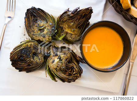 Top view of grilled artichokes with romesco 117860822