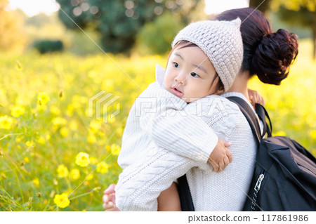 Parents and children walking in autumn park Yellow flower field 117861986