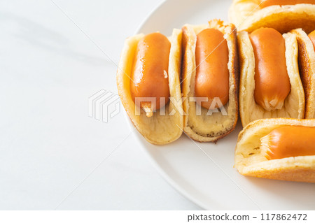 flat pancake roll with sausage 117862472