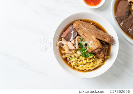 egg noodles with stewed and braised duck in brown soup egg noodles with stewed and braised duck in brown soup 117862606