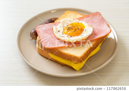 bread toasted cheese topped ham and fried egg with pork sausage bread toasted cheese topped ham and fried egg with pork sausage 117862658