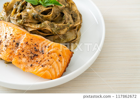 pesto fettuccine spaghetti pasta with grilled salmon fillet pesto fettuccine spaghetti pasta with grilled salmon fillet 117862672