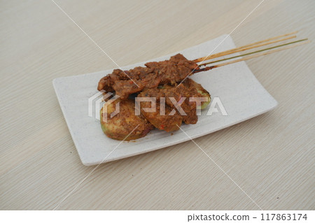 chicken satay on a white plate as a background 117863174