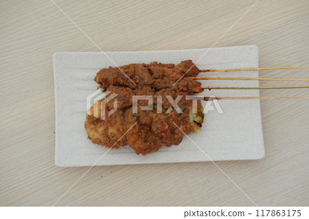 chicken satay on a white plate as a background chicken satay on a white plate as a background 117863175