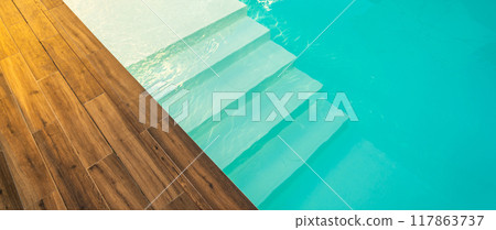 Swimming pool entrance steps with clean blue water at modern villa Swimming pool entrance steps with clean blue water at modern villa 117863737