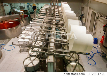 Interior of the cheese dairy factory. Equipment at cheese dairy plant Interior of the cheese dairy factory. Equipment at cheese dairy plant 117864738