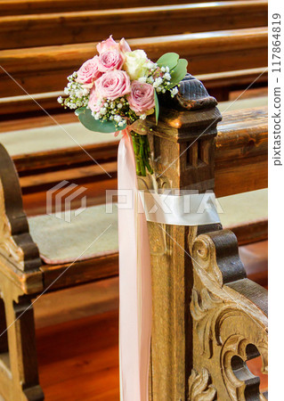 Close-up of a beautiful flower wedding decoration in church Close-up of a beautiful flower wedding decoration in church 117864819