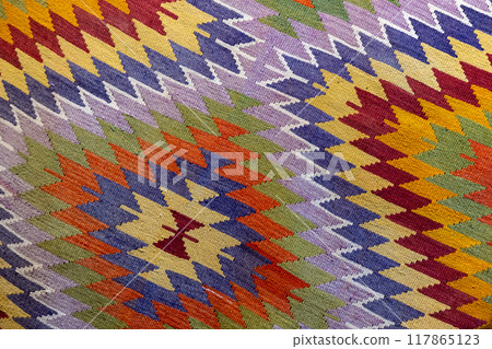 Colorful woolen carpet with traditional ethnic geometric ornament. Close up Colorful woolen carpet with traditional ethnic geometric ornament. Close up 117865123