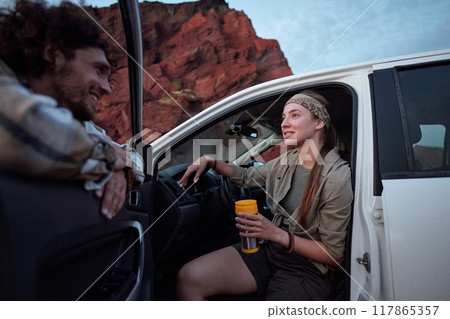 Travelers chatting by pickup truck 117865357